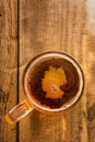 Germanic beer concept, Germany silhouette on foam in beer glass on wooden table.