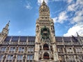 Germany, Bavaria, Munich, Marienplatz. Famous clock tower and part of the facade of the New Town Hall Neues Rathaus in the city Royalty Free Stock Photo