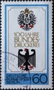 GERMANY, Berlin - CIRCA 1979: a postage stamp from Germany, Berlin showing Reichsadler and Bundesadler. Text: 100 years of Bundesd Royalty Free Stock Photo