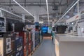Germany Berlin October 31, 2025. Aisle inside an electronics store lined with coffee machines and televisions. Royalty Free Stock Photo