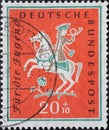 GERMANY - CIRCA 1958: a charity postage stamp printed in Germany showing an rider with hunting clothes and horn on a horse. Text: