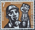 GERMANY - CIRCA 1957: This charity postage stamp shows a miner with a miner`s lamp. The background color is brown