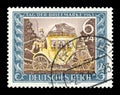 GERMANY - CIRCA 1943: German historical stamp: A coachman on an old mail coach with suitcases at the top and the symbol of the pos