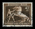 GERMANY - CIRCA 1939: German historical stamp: A tamer tames two horses. 6th annual German horse racing championship `Brown ribbon