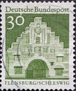 GERMANY - CIRCA 1966: a postage stamp from Germany, showing buildings in Germany. The north gate in Flensburg Schleswig