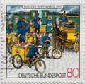 GERMANY - CIRCA 1987 : a postage stamp from Germany, showing the loading of rail mail in Prussia around 1897. Day of the Postal s