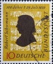 GERMANY - CIRCA 1956: This postage stamp in ocher yellow shows the portrait of the composer Robert Schumann against the background