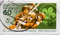 GERMANY - CIRCA 1985 : a postage stamp from Germany, showing  a lily emblem and young boy scouts. World Scout Conference Royalty Free Stock Photo