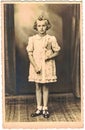 Retro photo shows girl and her first communion. Black & white vintage photography. Studio portrait