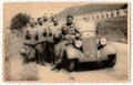 Vintage photo shows German Nazi soldiers stand at convertible