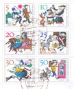 A block of postage stamps from Germany which depicts a German folk tale about a magic table, a donkey and a truncheon