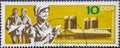 GERMANY, DDR - CIRCA 1967: a postage stamp from Germany, GDR showing an agricultural estate with silos and modern farmers