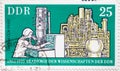 GERMANY, DDR - CIRCA 1975 : a postage stamp from Germany, GDR showing an electron microscope and chemical plant in theory and pra