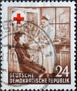 GERMANY, DDR - CIRCA 1953 : a postage stamp from Germany, GDR showing First aid service in the medical room of an industrial compa