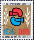 GERMANY, DDR - CIRCA 1965 : a postage stamp from Germany, GDR showing a graphic representation of boxing gloves, laurel branches.