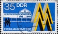 GERMANY, DDR - CIRCA 1986 : a postage stamp from Germany, GDR showing the historic trade fair emblem, trade fair building 1946. Le