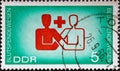 GERMANY, DDR - CIRCA 1966  : a postage stamp from Germany, GDR showing the international symbol for blood donation. Cooperation be Royalty Free Stock Photo