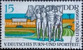 GERMANY, DDR - CIRCA 1969: a postage stamp from Germany, GDR showing male and female gymnasts with flags. Text: German gymnastics