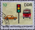 GERMANY, DDR - CIRCA 1969: a postage stamp from Germany, GDR showing a painting of a traffic light with motor vehicles. Text: Alwa