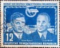 GERMANY, DDR - CIRCA 1950: a postage stamp from Germany, GDR showing Pawel Bykow fast movers and Erich Wirth in front of the sym Royalty Free Stock Photo