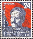 GERMANY, DDR - CIRCA 1951 : a postage stamp from Germany, GDR showing a portrait of the politician Karl Liebknecht in front of a r