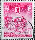 GERMANY, DDR - CIRCA 1955 : a postage stamp from Germany, GDR showing Racing cyclist, coat of arms of Prague, Berlin, Warsaw. VII