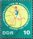 GERMANY, DDR - CIRCA 1965 : a postage stamp from Germany, GDR showing a runner in the cross-country run. World Championships in M