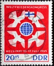 GERMANY, DDR - CIRCA 1965 : a postage stamp from Germany, GDR showing some peace doves around earth globe, flag of Finland. World