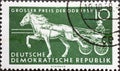 GERMANY, DDR - CIRCA 1958 : a postage stamp from Germany, GDR showing a team of horses at a trotting race. Text: Horse racing Gran Royalty Free Stock Photo