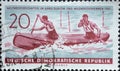 GERMANY, DDR - CIRCA 1961 : a postage stamp from Germany, GDR showing two athletes at the race in the Canadian two-man. Text: Worl