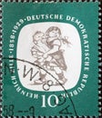 GERMANY, DDR - CIRCA 1958 : a postage stamp from Germany, GDR showing two playing children `ZillegÃÂ¶ren`. 100th birthday of Hei