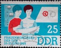 GERMANY, DDR - CIRCA 1964 : a postage stamp from Germany, GDR showing two technicians at the control cabinet, transistor circuit.