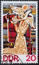 GERMANY, DDR - CIRCA 1975 : a postage stamp from Germany, GDR showing a work of art with a hand and a dove of peace. 25 years of E