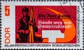 GERMANY, DDR - CIRCA 1967: a postage stamp from Germany, GDR showing a worker with a red flag. Text: 50th anniversary of the great