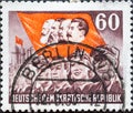 GERMANY, DDR - CIRCA 1953: a postage stamp from Germany, GDR showing Workers, flag with head images of Marx, Engels, Lenin and Sta Royalty Free Stock Photo