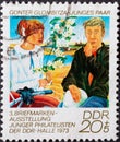 GERMANY, DDR - CIRCA 1973 : a postage stamp from Germany, GDR showing a young couple`; Painting by GÃÂ¼nter Glombitza. 3rd stamp ex