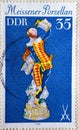 GERMANY, DDR - CIRCA 1979 : a postage stamp from Germany, GDR showing an antique classic figure harlequin with beer mug. Meissen