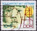 GERMANY, DDR - CIRCA 1972: a postage stamp from Germany, GDR showing a child`s face, symbols of construction Text: Solidarity wit