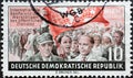 GERMANY, DDR - CIRCA 1955 : a postage stamp from Germany, GDR showing a demonstration, flag of the world trade union confederation