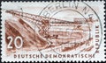 GERMANY, DDR - CIRCA 1957 : a postage stamp from Germany, GDR showing the drawing of a conveyor bridge in the open pit for lignite Royalty Free Stock Photo