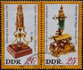GERMANY, DDR - CIRCA 1980 : a postage stamp from Germany, GDR showing a Huntley microscope; London 1740. Magny and a microscope; Royalty Free Stock Photo