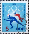 GERMANY, DDR - CIRCA 1968: a postage stamp from Germany, GDR showing speed skater with Olympic rings. Text: Olympic Winter Games G