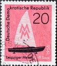 GERMANY, DDR - CIRCA 1956 : a postage stamp from Germany, GDR showing a sport sailing boat, sample fair symbol. Leipzig Autumn Fai