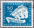 GERMANY, DDR - CIRCA 1950: a postage stamp from Germany, GDR showing Three singing masks, excerpt with the sequence B-A-C-H. Bach