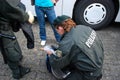 A police woman inspects a girl s bag