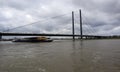 Germany, Dusseldorf - February 20, 2020: A loaded vessel in containers floats along the Rhine and under the Oberkassel bridge in