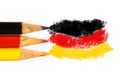 Germany flag colours in coloured pencils in black, red and gold in a closeup photo isolated on white background with space text Royalty Free Stock Photo