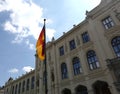 Germany flag before facade of Five Continents Museum in Munich on sunny day Royalty Free Stock Photo