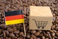 Germany flag with shopping cart on coffee bean, import export trade online commerce concept Royalty Free Stock Photo