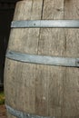 Germany. Heidelberg Castle. Fragment of an old wooden vine barrel with an metall hoop on a dark background. Wooden barrel with